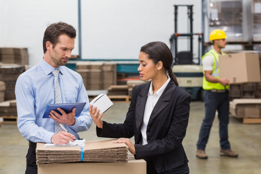 warehouse managers holding box looking tablet pc | Why Professional Certifications are the Secret to Employee Retention in Shipping and Transport